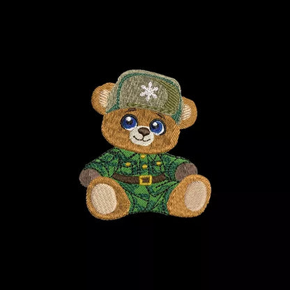 Motif de broderie machine représentant un ourson habillé en vêtement d'hiver et chapeau ayant un flocon de neige.